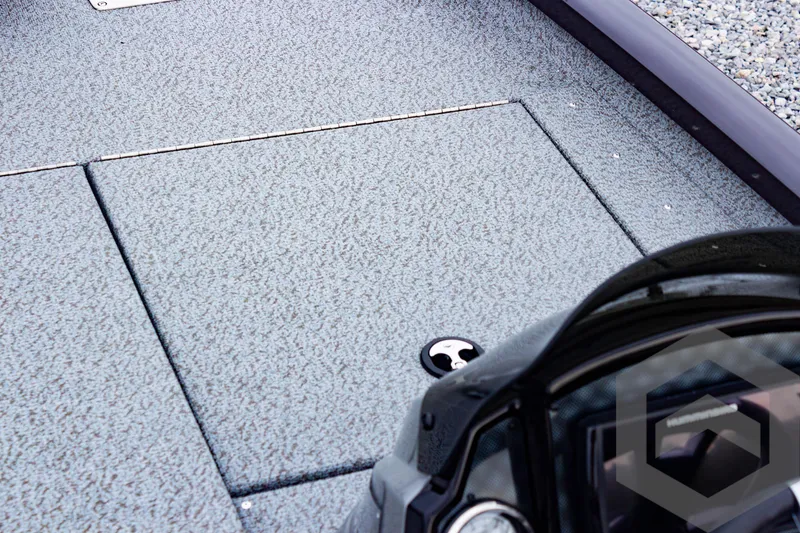 Slide: The Image of 2025 G3 Sportsman 1810 boat deck with storage compartment and steering console. - 21