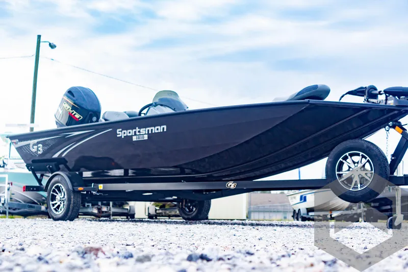 Slide: The Image of 2025 G3 Sportsman 1810 boat on trailer, sleek black design, outdoor setting. - 3