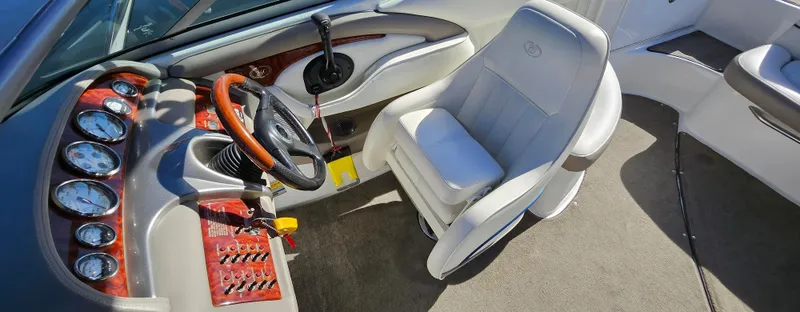 Slide: The Image of Interior of a 2006 Cobalt 240 boat featuring a sleek dashboard and comfortable seating. - 10