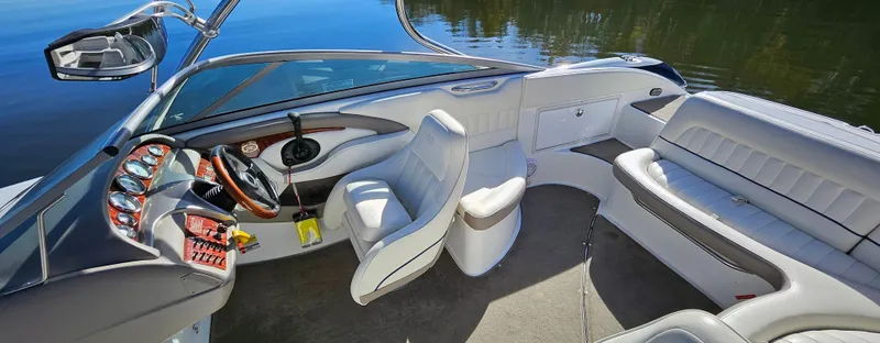 Slide: The Image of Interior of a 2006 Cobalt 240 boat with luxurious seating and modern dashboard. - 5