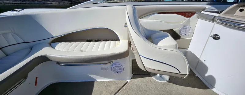 Slide: The Image of 2006 Cobalt 240 boat interior with white leather seating and modern design. - 7