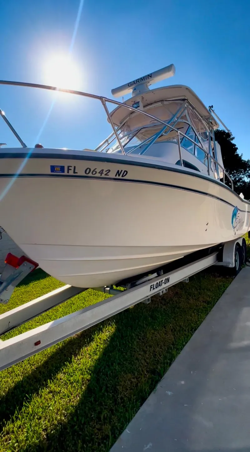 Slide: The Image of 2006 Grady-White 282 Sailfish boat on trailer under bright sun. - 1
