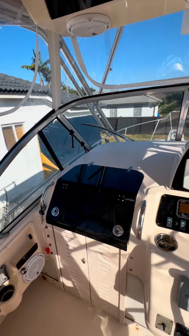 Slide: The Image of 2006 Grady-White 282 Sailfish boat cockpit with modern controls and clear canopy. - 11