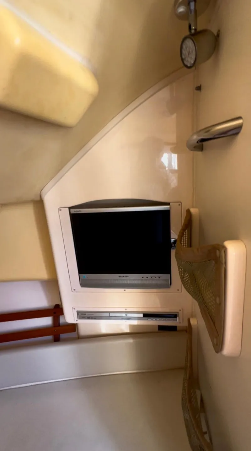 Slide: The Image of Interior of 2006 Grady-White 282 Sailfish boat with TV and seating area. - 17