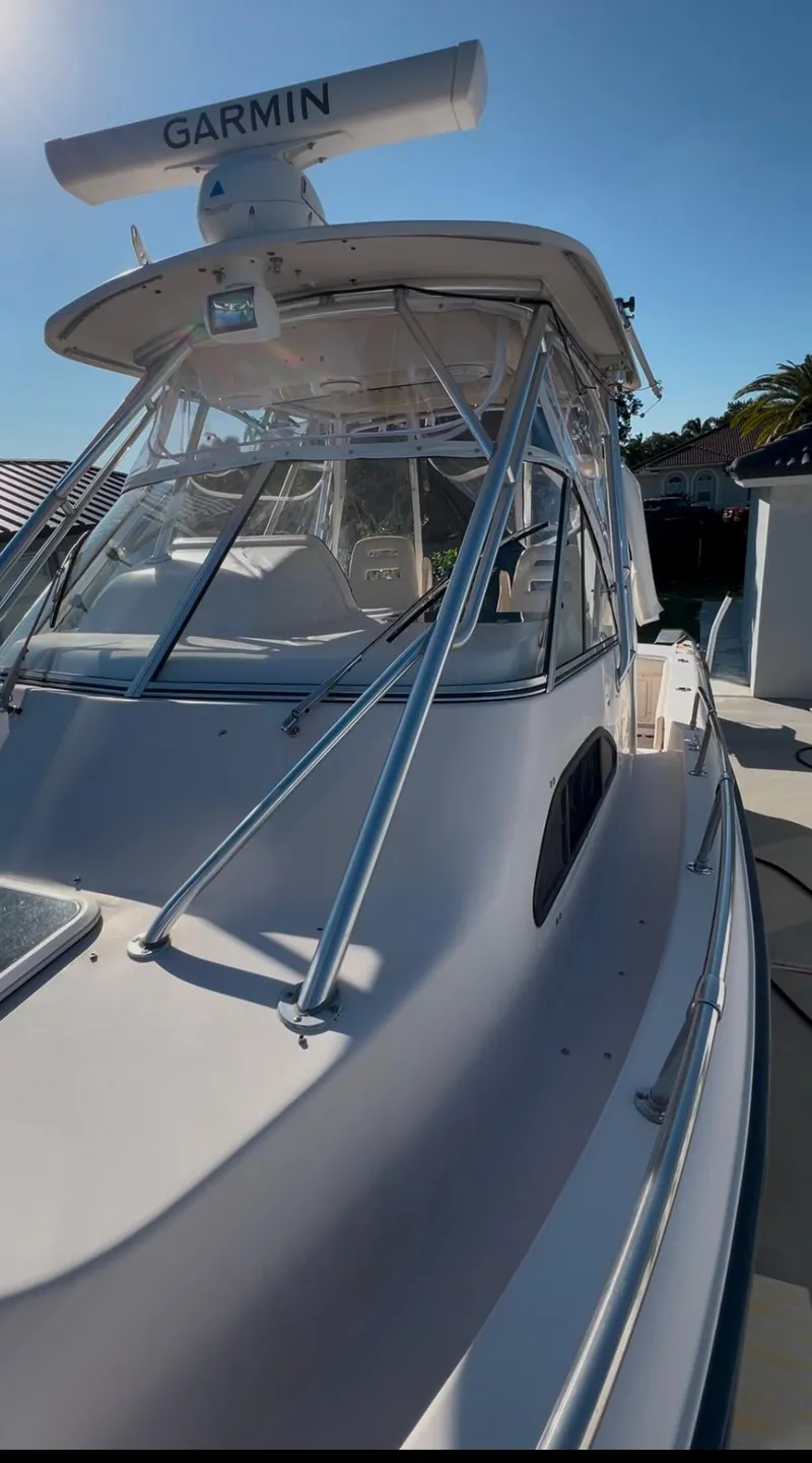 Slide: The Image of 2006 Grady-White 282 Sailfish boat with Garmin radar, docked under clear skies. - 18