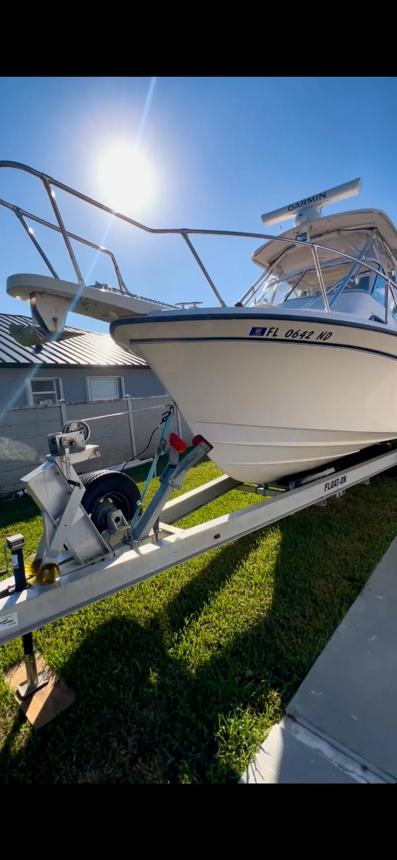 Slide: The Image of 2006 Grady-White 282 Sailfish boat on trailer under bright sun. - 2