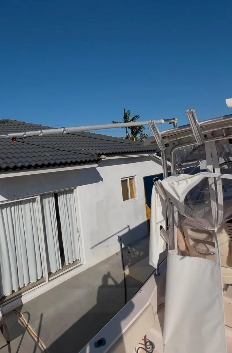 Slide: The Image of 2006 Grady-White 282 Sailfish boat near a house under clear blue sky. - 20