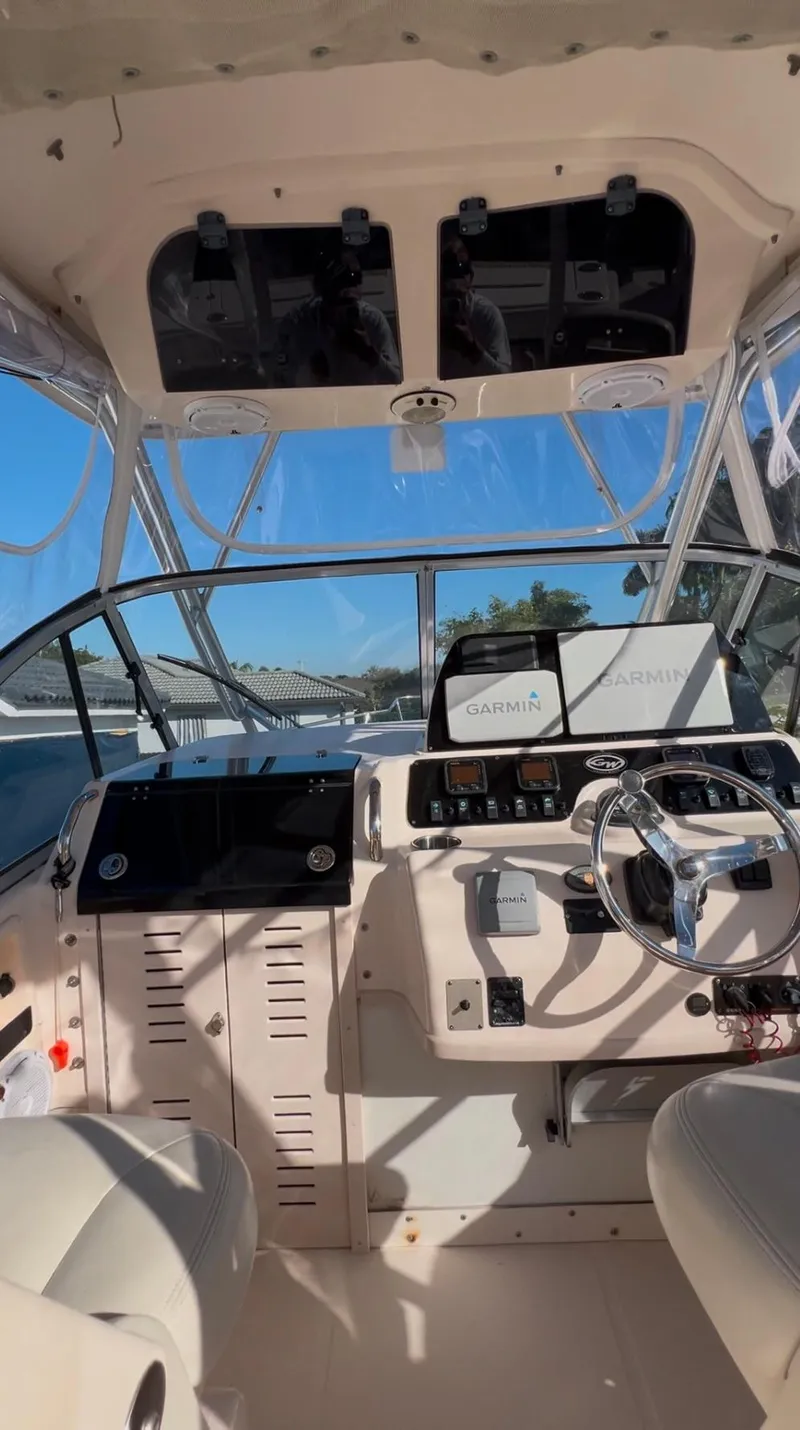 Slide: The Image of 2006 Grady-White 282 Sailfish boat cockpit with steering wheel and controls. - 4