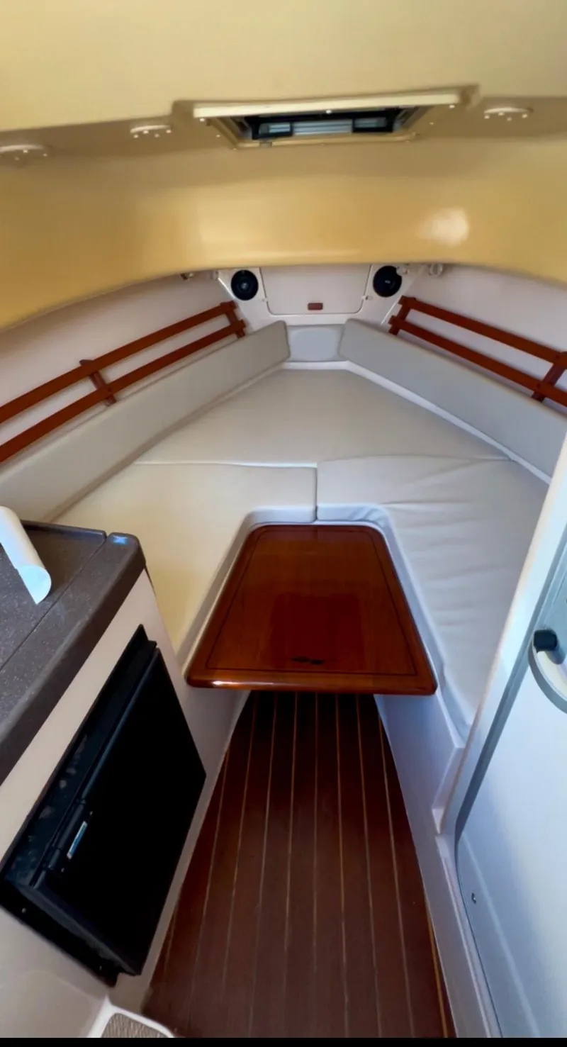 Slide: The Image of Interior cabin of 2006 Grady-White 282 Sailfish boat with wood accents and seating. - 5