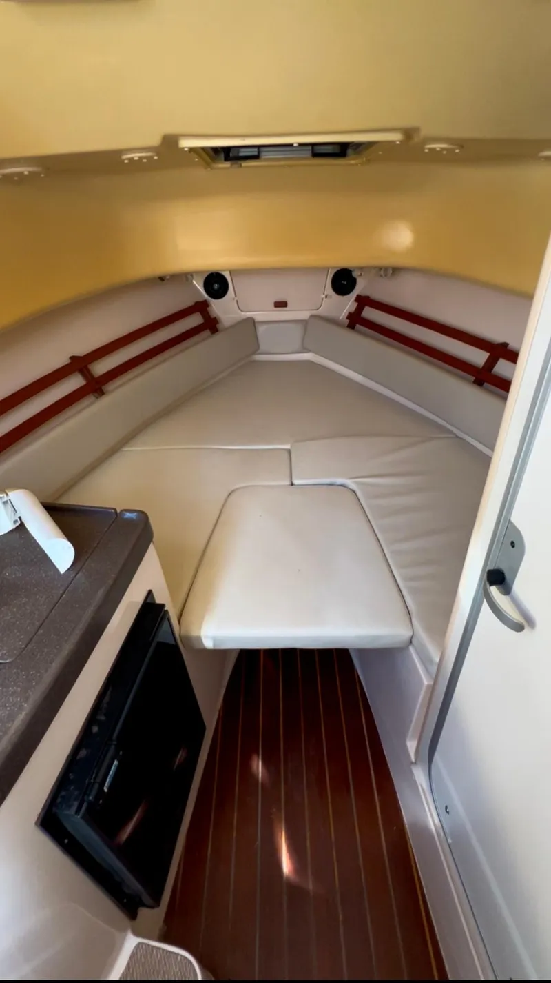 Slide: The Image of Interior of 2006 Grady-White 282 Sailfish boat with cushioned seating and wood flooring. - 7