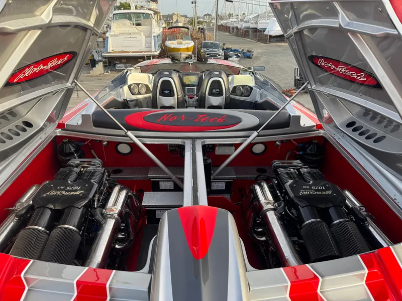 Slide: The Image of 2010 Nor-Tech 4000 Roadster with open engine compartment, showcasing powerful dual engines. - 11