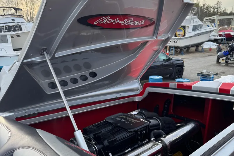 Slide: The Image of 2010 Nor-Tech 4000 Roadster engine compartment with open hood, showcasing powerful marine engine. - 13