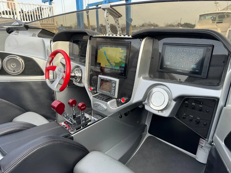 Slide: The Image of 2010 Nor-Tech 4000 Roadster cockpit with red steering wheel and advanced navigation displays. - 18