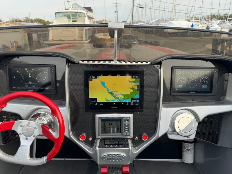 Slide: The Image of Dashboard of 2010 Nor-Tech 4000 Roadster with navigation screens and red steering wheel. - 19