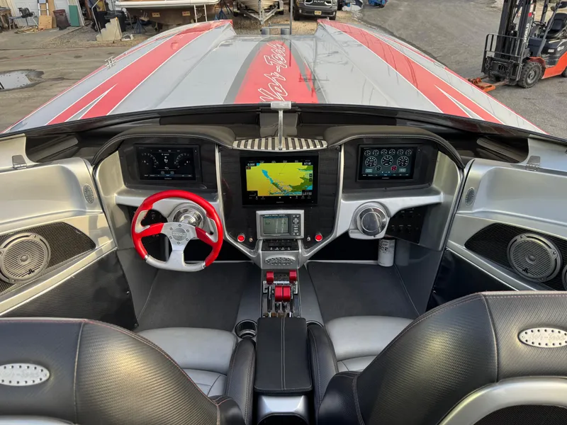 Slide: The Image of Interior of 2010 Nor-Tech 4000 Roadster with red steering wheel and advanced navigation system. - 20