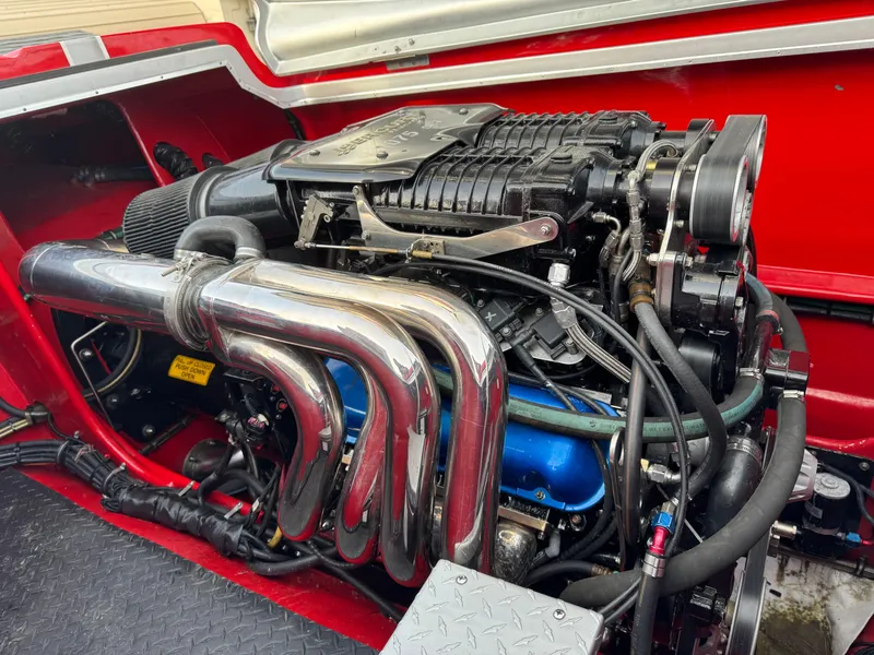 Slide: The Image of 2010 Nor-Tech 4000 Roadster engine with chrome exhaust and red interior detailing. - 9