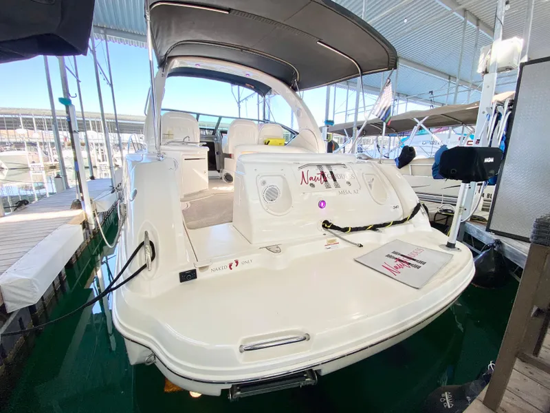 Slide: The Image of 2007 Sea Ray 340 Sundancer docked in a marina, showcasing its spacious deck and sleek design. - 1