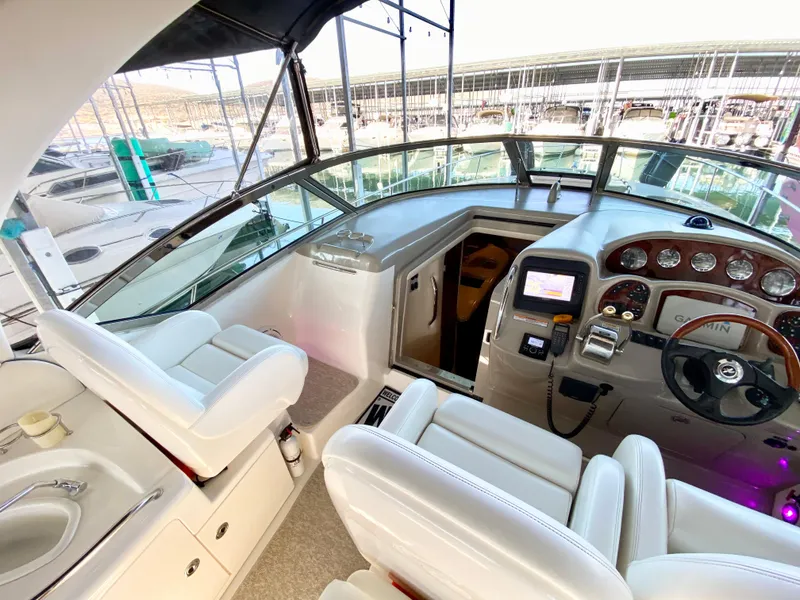 Slide: The Image of Interior view of 2007 Sea Ray 340 Sundancer yacht cockpit with white seating and control panel. - 10