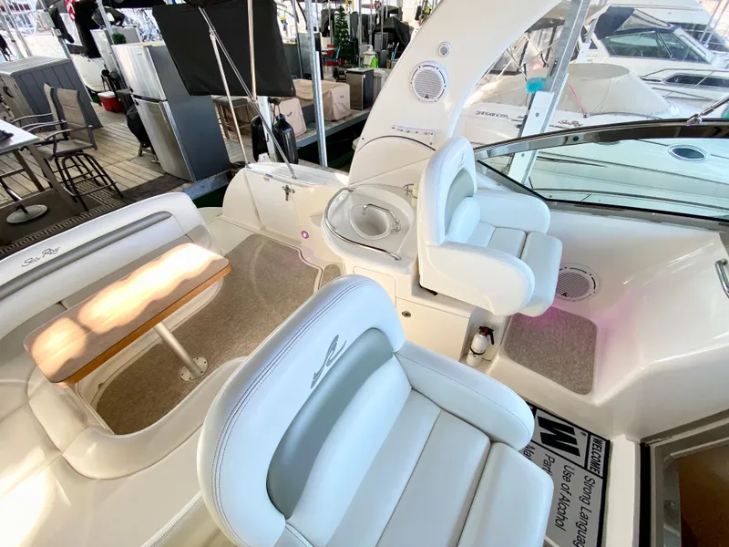 Slide: The Image of 2007 Sea Ray 340 Sundancer cockpit with white seating and table. - 13