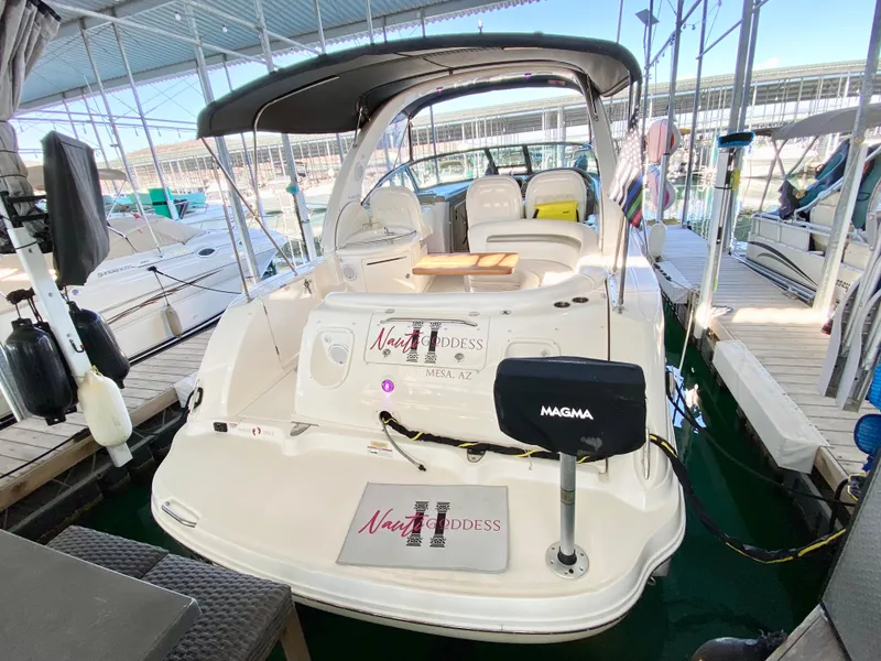 Slide: The Image of 2007 Sea Ray 340 Sundancer docked in marina, featuring spacious seating and covered deck. - 2