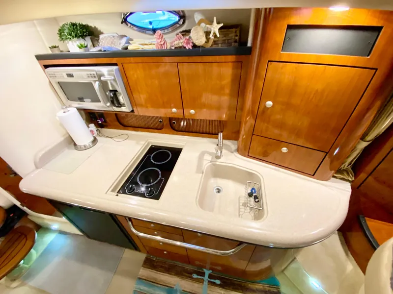 Slide: The Image of Luxurious 2007 Sea Ray 340 Sundancer yacht kitchen with modern amenities and elegant wood cabinetry. - 26
