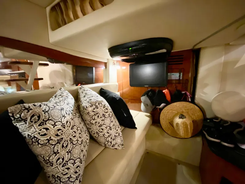 Slide: The Image of Interior of 2007 Sea Ray 340 Sundancer with patterned pillows and a mounted TV. - 30