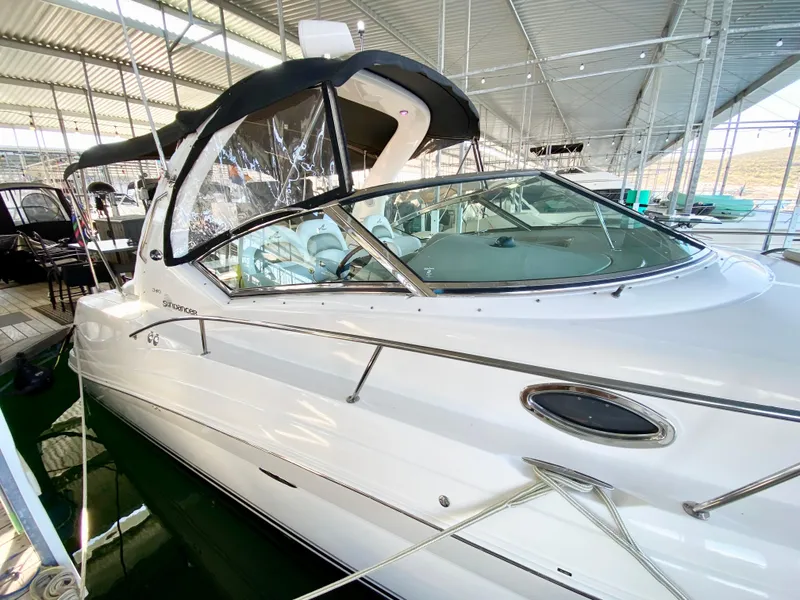 Slide: The Image of 2007 Sea Ray 340 Sundancer yacht docked in a marina under a metal roof. - 7