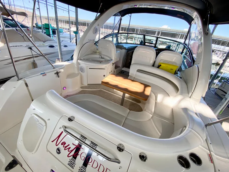 Slide: The Image of 2007 Sea Ray 340 Sundancer yacht interior with seating and table in marina. - 8