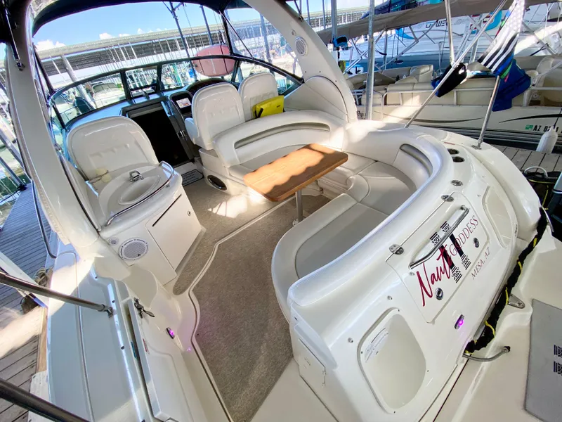 Slide: The Image of 2007 Sea Ray 340 Sundancer boat interior with seating and table in marina. - 9