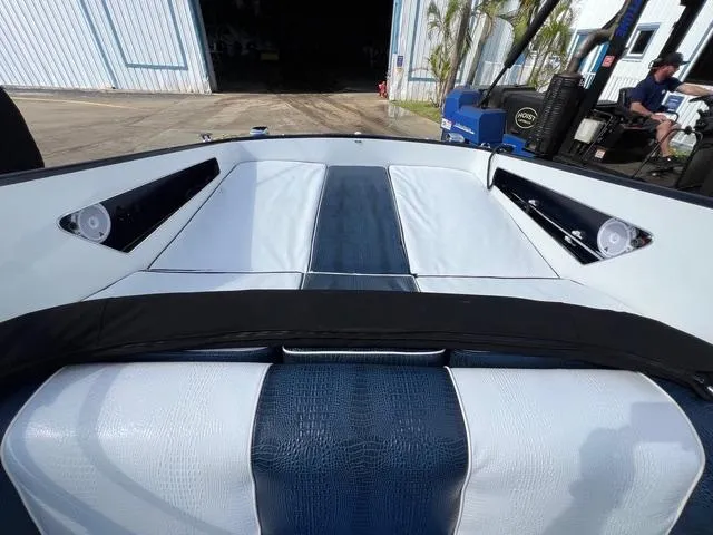 Slide: The Image of Interior view of a 1977 Riva 310 boat with blue and white seating. - 1