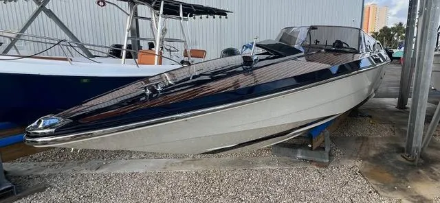 Slide: The Image of 1977 Riva 310 speedboat on display, sleek design, docked outdoors. - 11