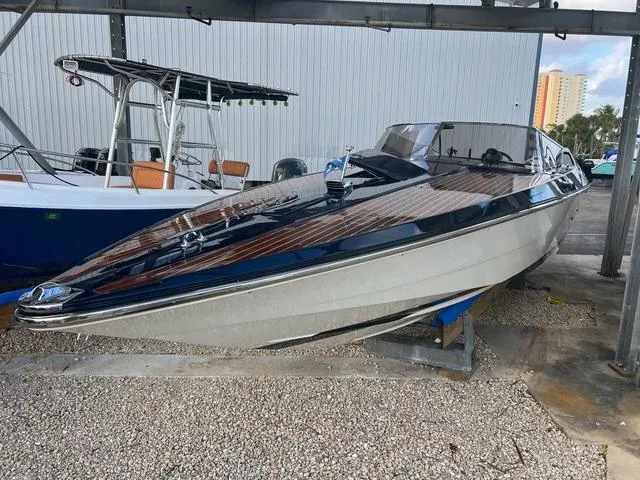 Slide: The Image of 1977 Riva 310 speedboat on display, featuring sleek design and classic wooden accents. - 14