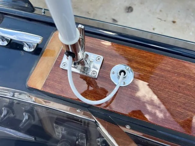 Slide: The Image of Close-up of a 1977 Riva 310 boat's wooden deck with antenna mount. - 16