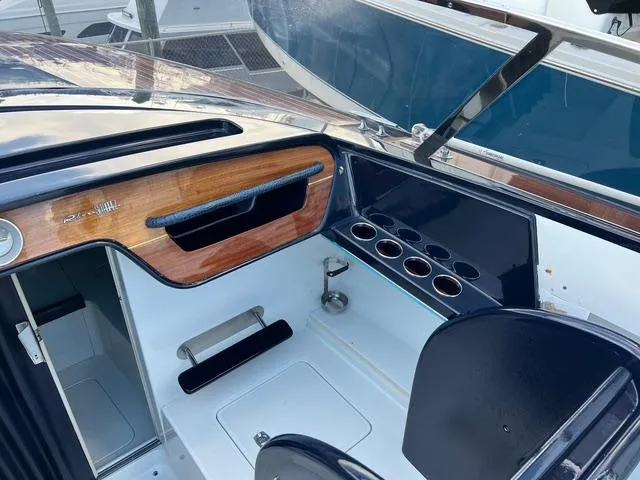 Slide: The Image of 1977 Riva 310 boat interior with wood accents and cup holders. - 17