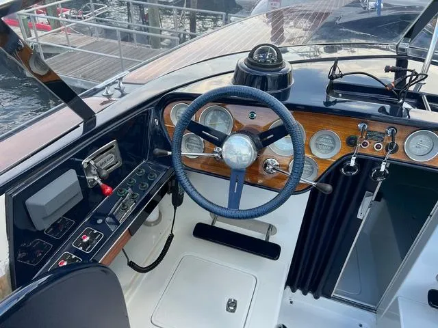 Slide: The Image of 1977 Riva 310 boat dashboard with steering wheel and gauges. - 18