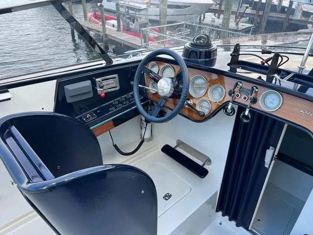 Slide: The Image of 1977 Riva 310 boat cockpit with classic steering wheel and instrument panel. - 19
