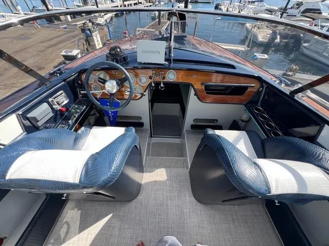 Slide: The Image of Interior of a 1977 Riva 310 boat with blue and white seating. - 2
