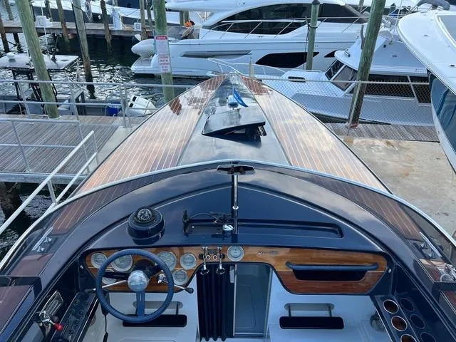Slide: The Image of 1977 Riva 310 boat with wooden deck, docked at marina. - 21