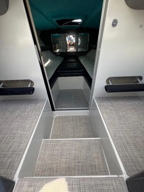 Slide: The Image of Interior of a 1977 Riva 310 boat with modern seating and carpeted flooring. - 3