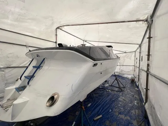 Slide: The Image of 1977 Riva 310 boat in storage tent, undergoing maintenance. - 33