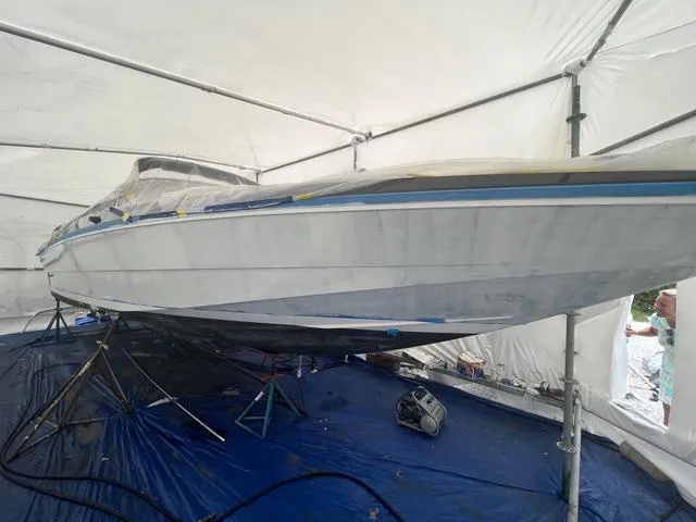 Slide: The Image of 1977 Riva 310 boat under restoration in a covered workshop. - 34