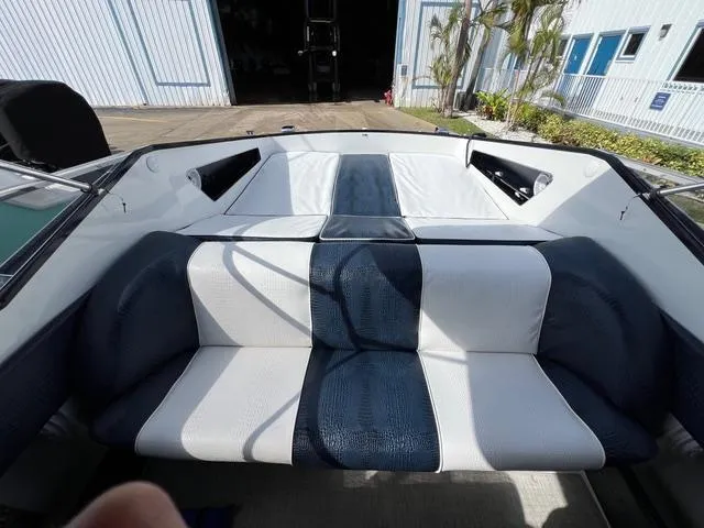 Slide: The Image of Interior of a 1977 Riva 310 boat with blue and white seating. - 4