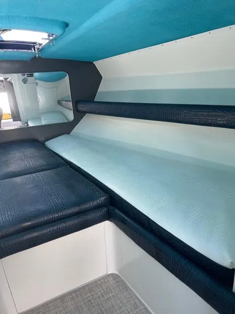 Slide: The Image of Interior of 1977 Riva 310 boat with blue and white seating. - 6