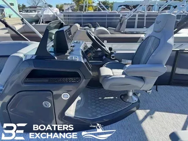 Slide: The Image of 2025 Bennington 22MSBSE boat cockpit with modern helm and comfortable captain's chair. - 7