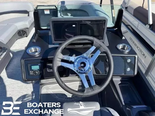 Slide: The Image of 2025 Bennington 22MSBSE boat dashboard with steering wheel and dual screens. - 8