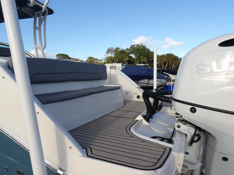 Slide: The Image of 2022 Stingray 269 DC boat with Suzuki outboard motor, featuring spacious seating and sleek design. - 10