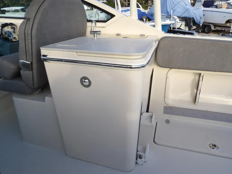 Slide: The Image of 2022 Stingray 269 DC boat interior with sink and seating area. - 17