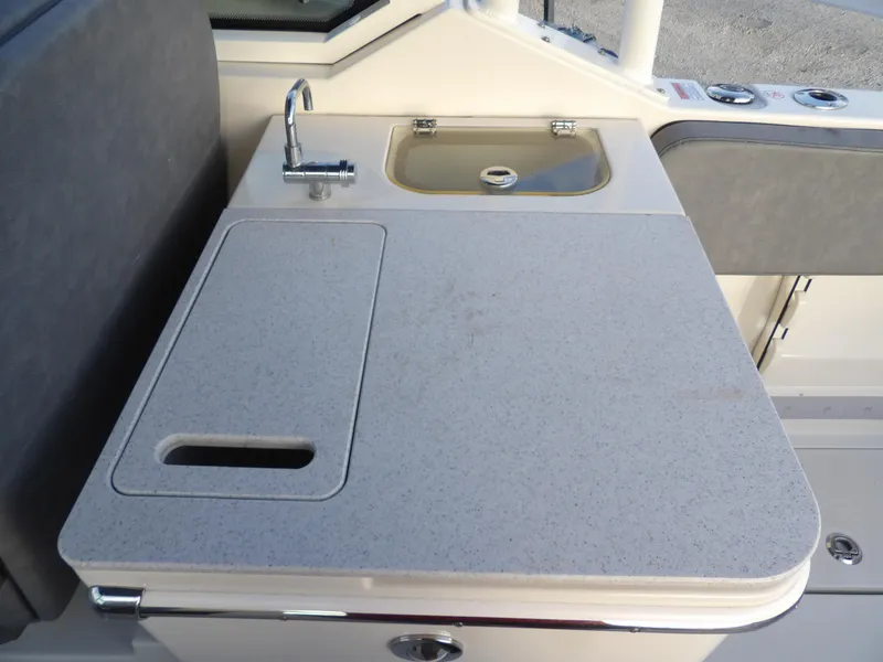 Slide: The Image of 2022 Stingray 269 DC boat kitchenette with sink and countertop. - 18