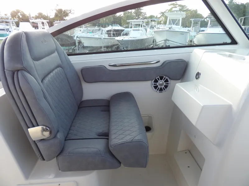 Slide: The Image of 2022 Stingray 269 DC boat interior with gray seating and window view. - 37