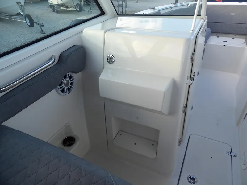 Slide: The Image of 2022 Stingray 269 DC boat interior with seating and storage compartments. - 38